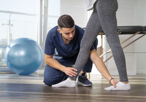 close-up-physiotherapist-helping-patient