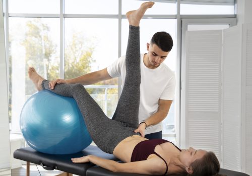 medium-shot-woman-exercising-with-gym-ball